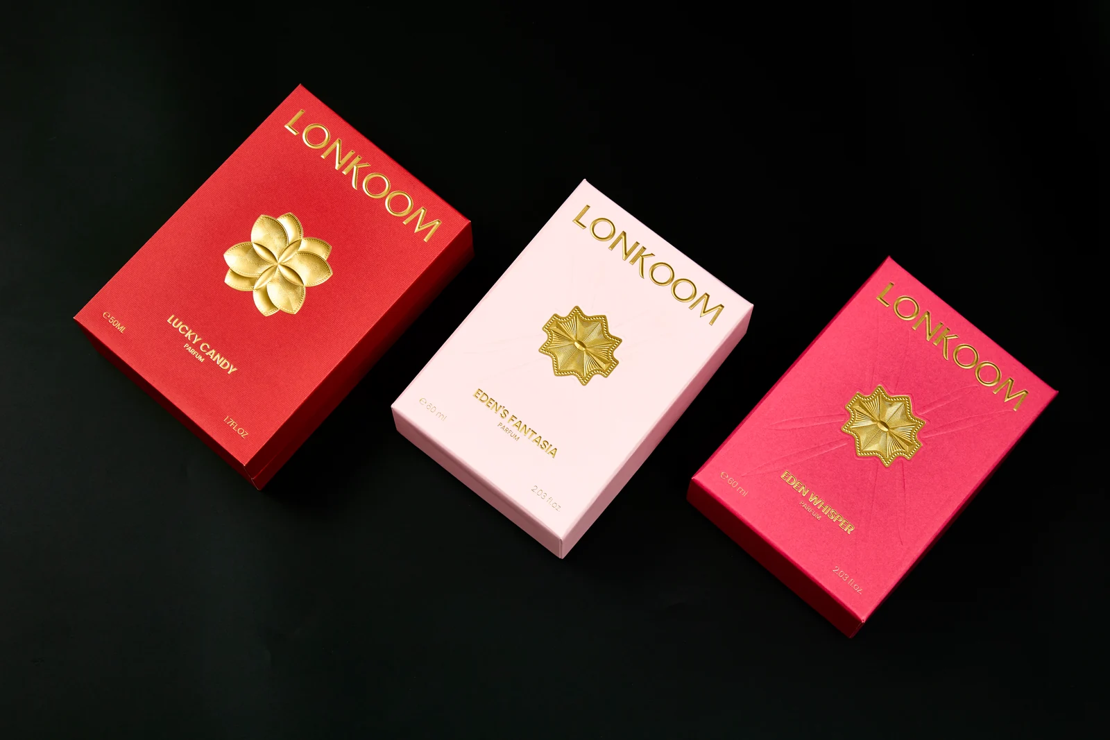 Fragrance boxes with floral emblems and gold-coloured printed details