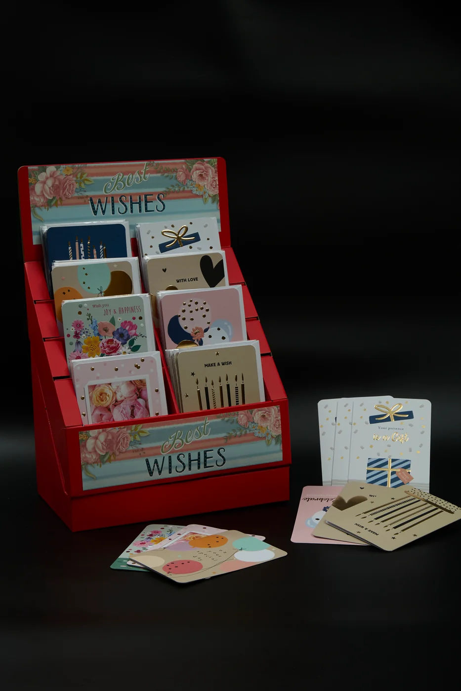 Greeting cards arranged in a red tiered countertop display